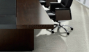 close up view of dark oak and leather conference table top