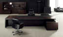 elegant office cabin with large table, rear storage unit and black leather chairs