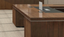 walnut wood executive desk with two wire boxes and leather writing pad