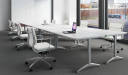 white laminate training tables with white leather chairs