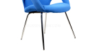 slim chrome legs of cushioned arm chair in fabric