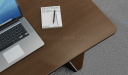 walnut veneer office table top with laptop and book