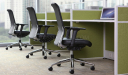 green workstation with black leather office chairs