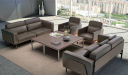 office lounge area with brown leather sofas