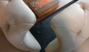 curved armrests of chesterfield sofa in taupe leather