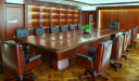rich boardroom with black leather chairs