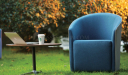 garden area with blue lounge chair in cashmere fabric and coffee table
