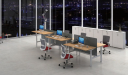 office with height adjustable workstation in a linear face to face setting.