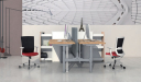two height adjustable workstations facing each other with storage cabinets