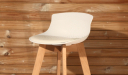 bar stool with white plastic seat and beech wood base